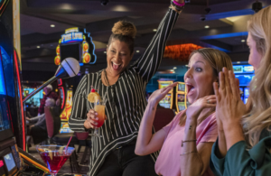 three ladies playing casino games and celebrating 
