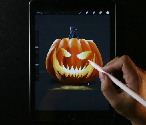 a hand drawing a pumpkin on a phone