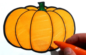 a hand holding an orange crayon drawing acute pumpkin